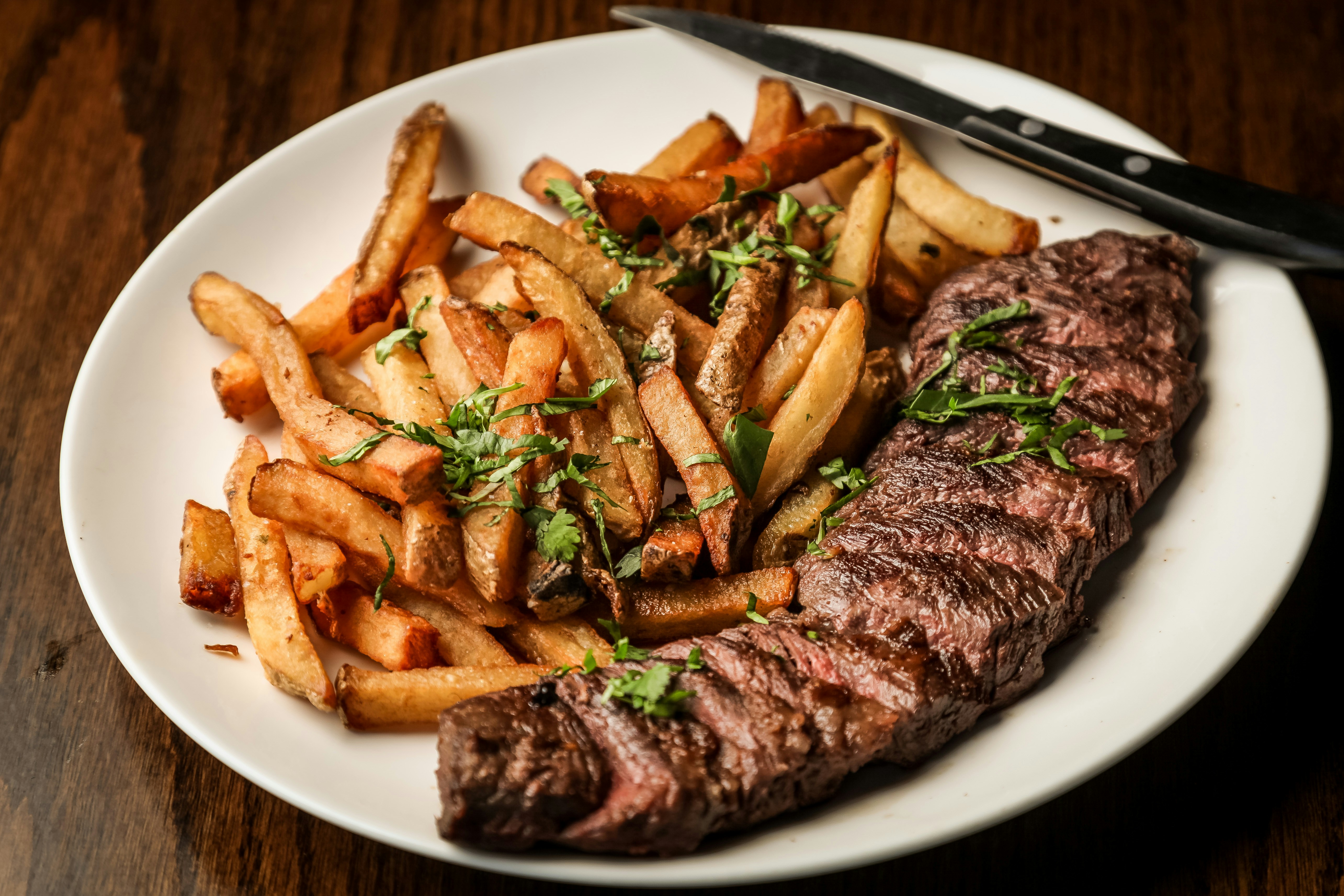 A delicious plate of steak frites served at a restaurant.